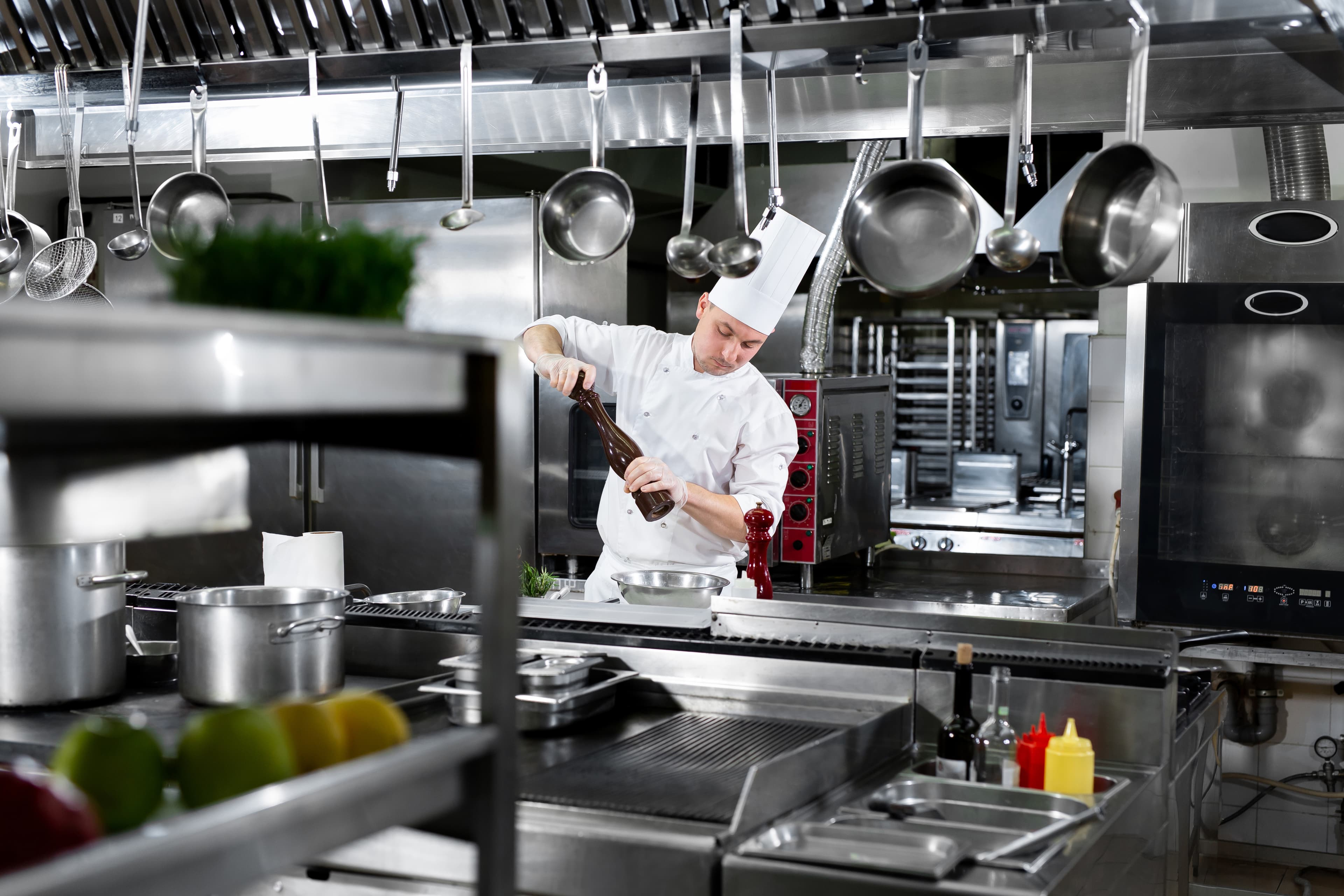 Chef seasoning at a Hemco-built stainless service line